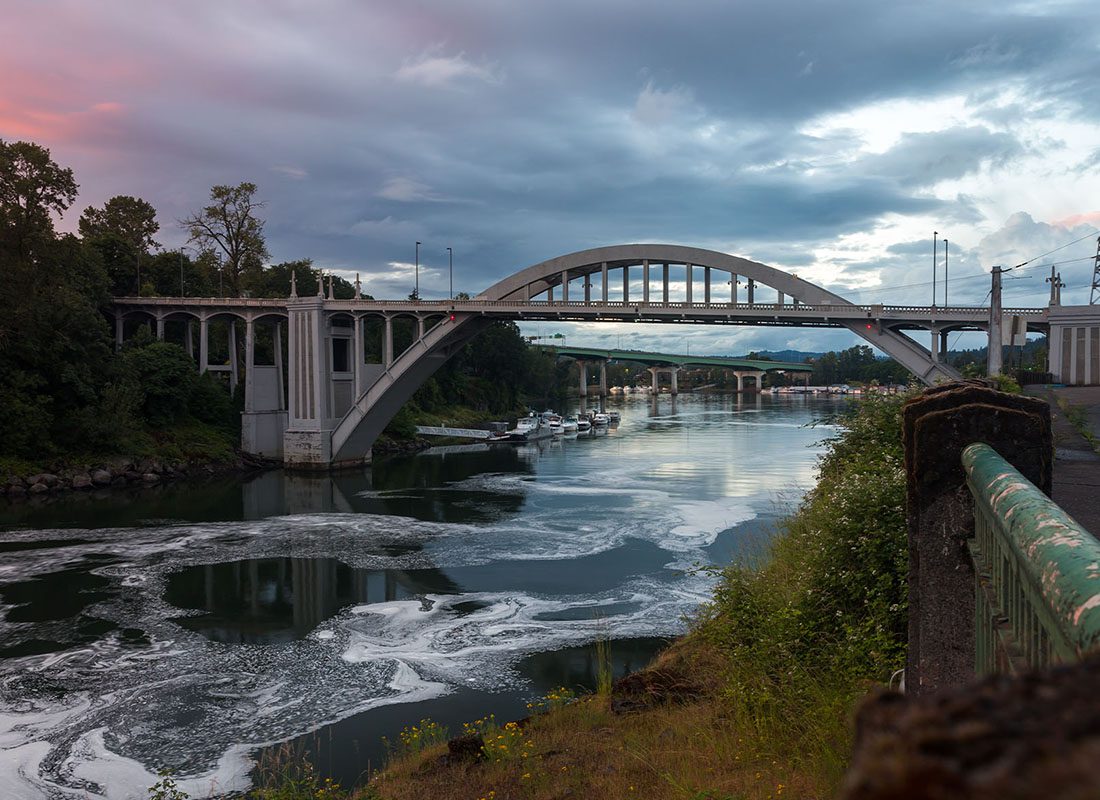 Contact - Dramatic Sunset Sky Over Arch Bridge and Willamette River in Oregon City at Dusk